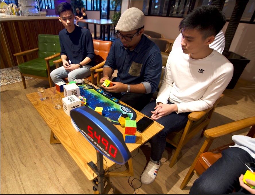 Muhammad Hariz Azizan (middle) solved the 3x3 in about 6 seconds.